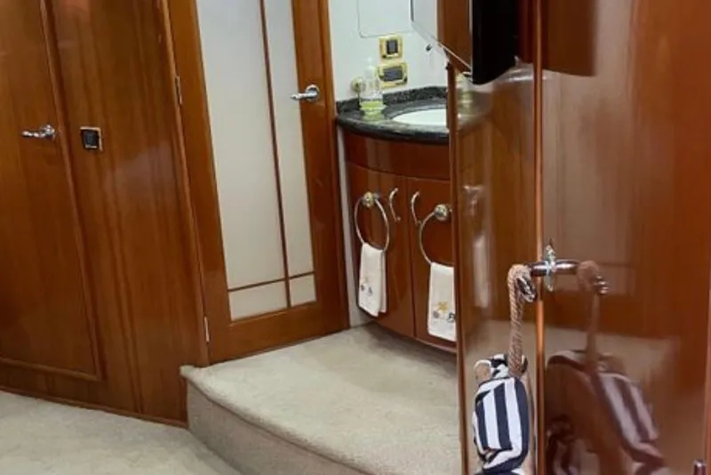 Slide: The Image of Interior of 2005 Carver 56 Voyager yacht, featuring elegant wood cabinetry and modern fixtures. - 20