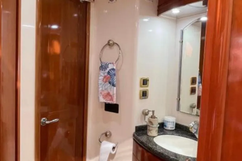 Slide: The Image of Luxurious bathroom in 2005 Carver 56 Voyager yacht with wooden accents and modern fixtures. - 25