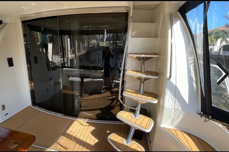 Slide: The Image of Luxurious 2005 Carver 56 Voyager yacht interior with elegant wooden steps and glass doors. - 3