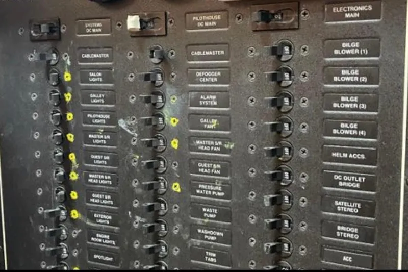 Slide: The Image of Electrical panel of a 2005 Carver 56 Voyager yacht with labeled switches and controls. - 30