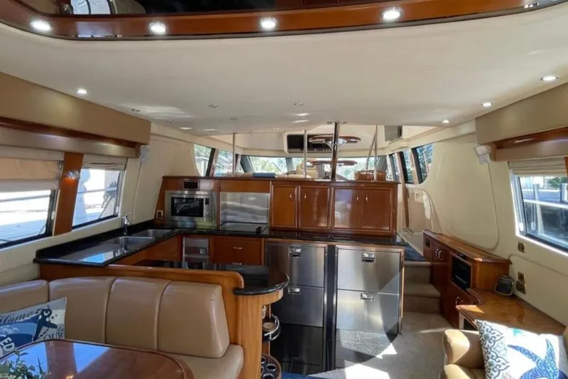 Slide: The Image of Luxurious interior of 2005 Carver 56 Voyager yacht with modern kitchen and seating area. - 7