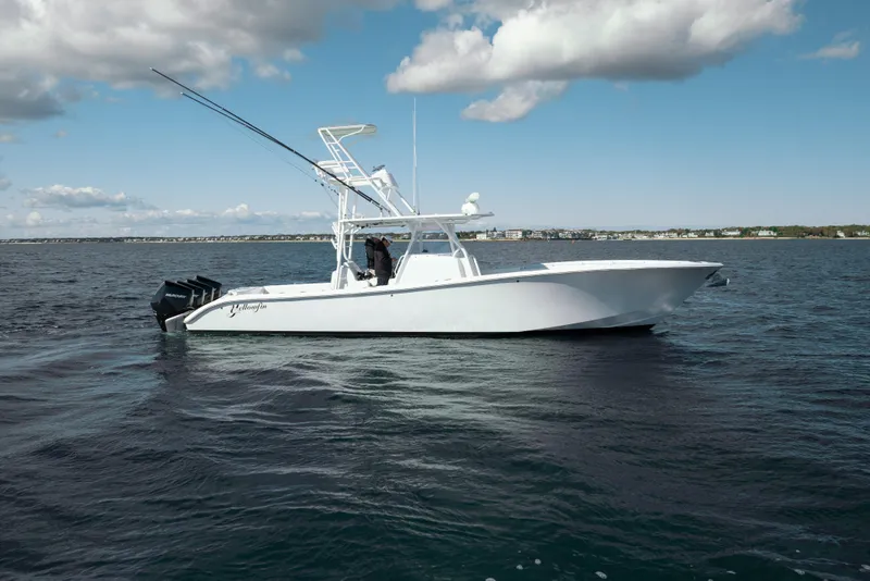 Slide: The Image of 2014 Yellowfin 39 Offshore boat on open water under a partly cloudy sky. - 15