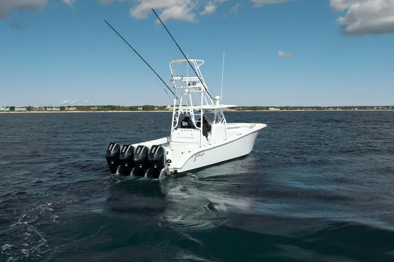 Slide: The Image of 2014 Yellowfin 39 Offshore boat with multiple outboard engines on open water. - 17