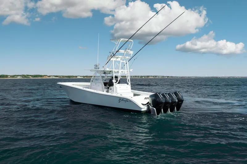 Slide: The Image of 2014 Yellowfin 39 Offshore boat on open water under a partly cloudy sky. - 19