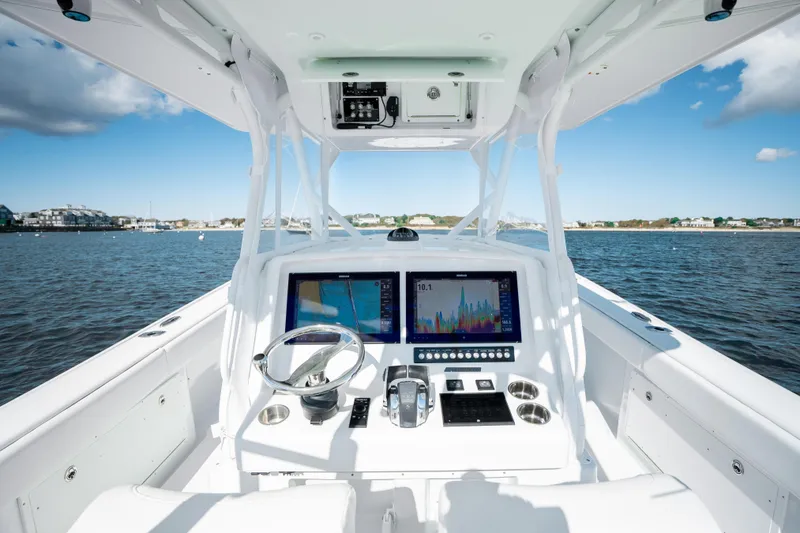Slide: The Image of 2014 Yellowfin 39 Offshore boat cockpit with navigation screens on open water. - 20