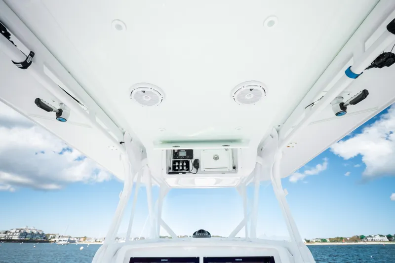 Slide: The Image of 2014 Yellowfin 39 Offshore boat console with speakers and equipment, under a clear blue sky. - 22