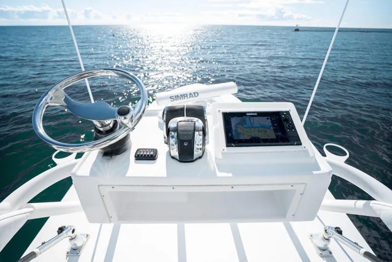 Slide: The Image of 2014 Yellowfin 39 Offshore boat helm with Simrad navigation system on open sea. - 23