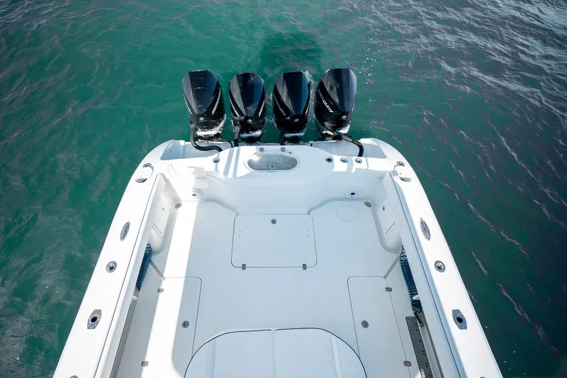 Slide: The Image of 2014 Yellowfin 39 Offshore boat with four powerful outboard engines on turquoise water. - 24