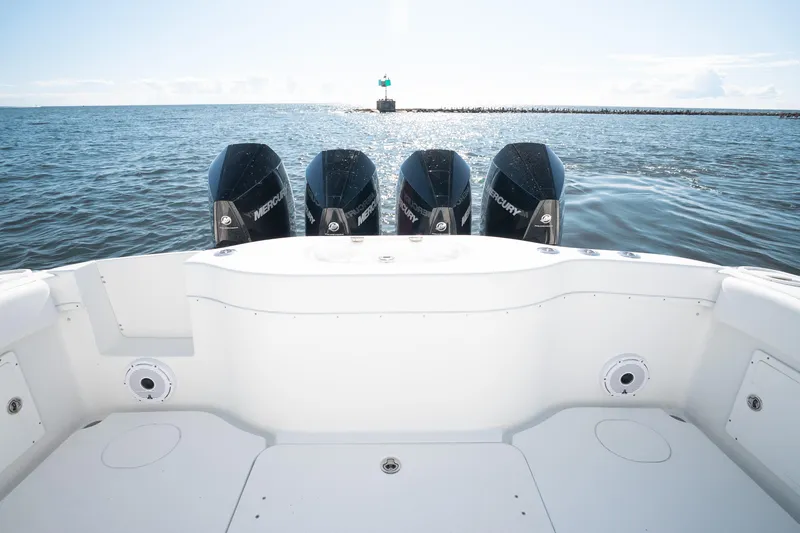 Slide: The Image of 2014 Yellowfin 39 Offshore boat with four Mercury engines on open water. - 25