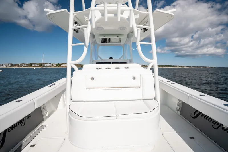 Slide: The Image of 2014 Yellowfin 39 Offshore boat on water, showcasing helm and seating area. - 26