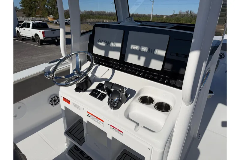 Slide: The Image of 2026 Sea Hunt Ultra 275 Coffin Box boat console with Garmin displays and steering wheel. - 12