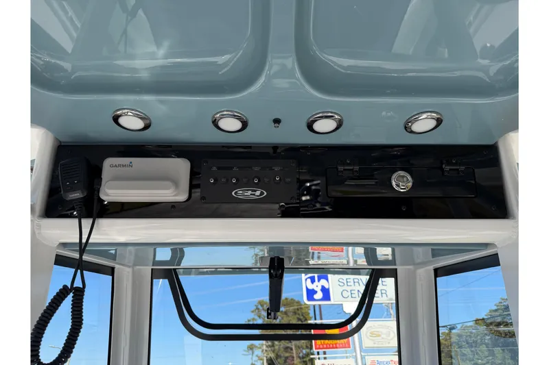 Slide: The Image of 2026 Sea Hunt Ultra 275 Coffin Box dashboard with Garmin equipment and overhead lighting. - 17
