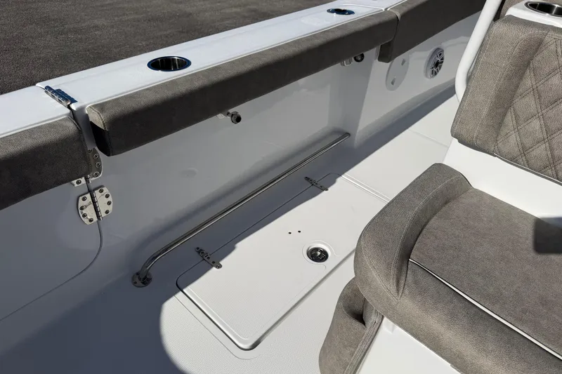 Slide: The Image of 2026 Sea Hunt Ultra 275 Coffin Box boat interior with cushioned seating and stainless steel fixtures. - 20