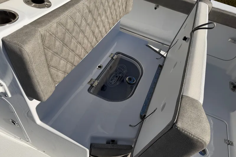 Slide: The Image of 2026 Sea Hunt Ultra 275 Coffin Box interior with cushioned seating and storage. - 21