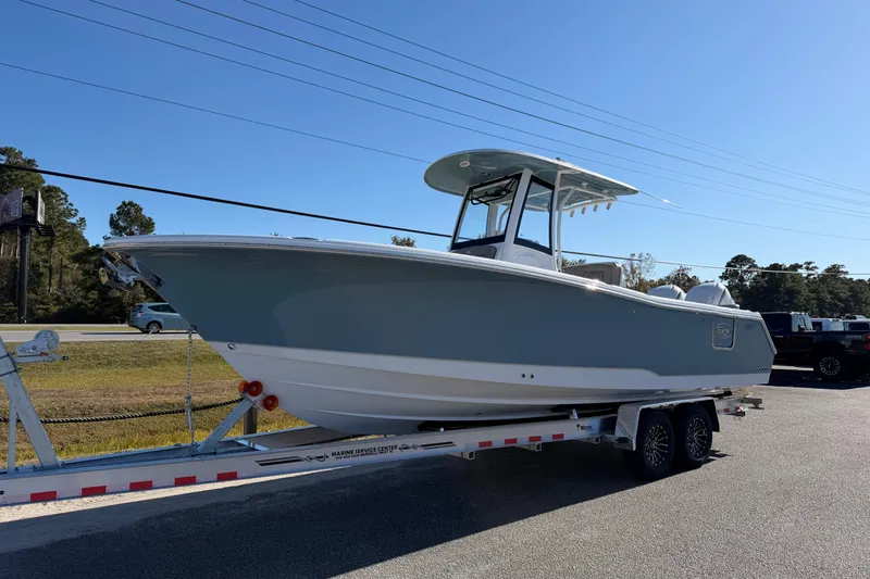 Slide: The Image of 2026 Sea Hunt Ultra 275 Coffin Box boat on trailer, parked outdoors. - 3