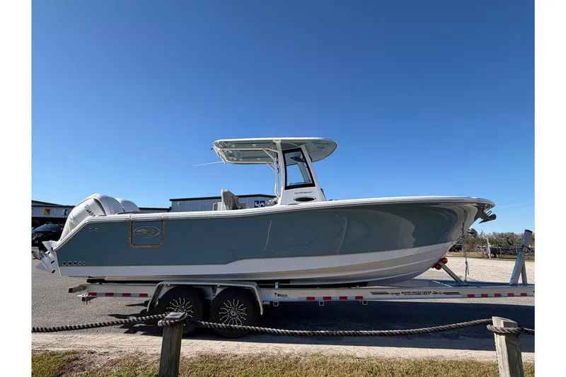 Slide: The Image of 2026 Sea Hunt Ultra 275 Coffin Box boat on trailer, clear sky background. - 5