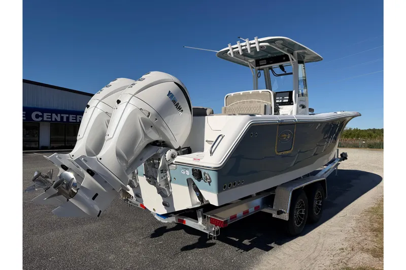 Slide: The Image of 2026 Sea Hunt Ultra 275 Coffin Box boat with dual Yamaha engines on a trailer. - 7