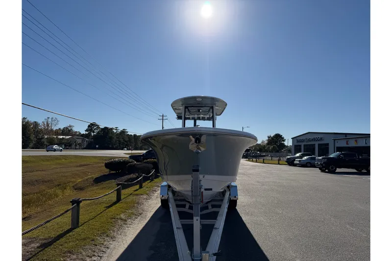 Slide: The Image of 2026 Sea Hunt Ultra 275 Coffin Box boat on trailer under bright sun. - 8