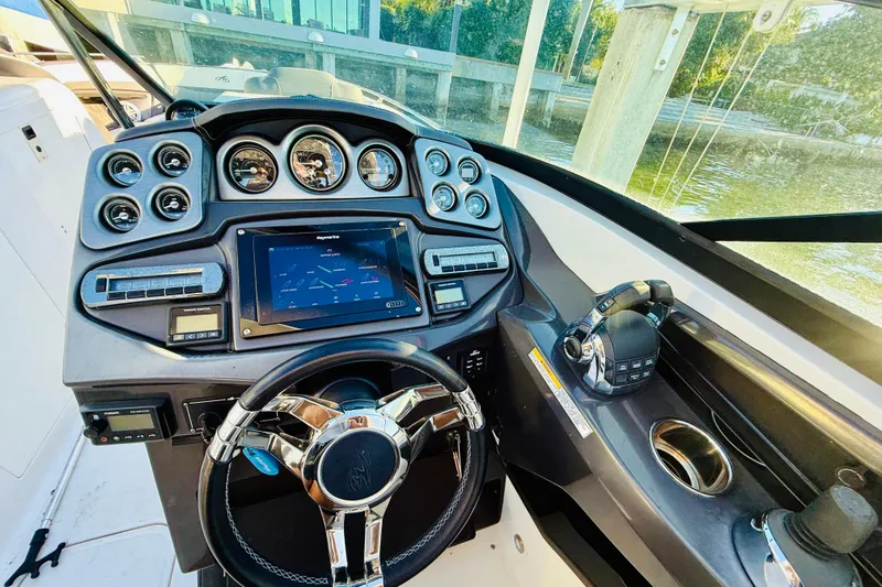 Slide: The Image of Cockpit of 2020 Monterey 328SS Super Sport boat with modern controls and steering wheel. - 13