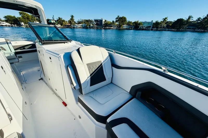 Slide: The Image of 2020 Monterey 328SS Super Sport boat interior with luxurious seating by the water. - 16