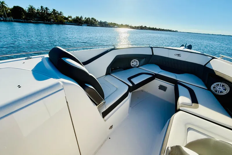 Slide: The Image of 2020 Monterey 328SS Super Sport boat interior with luxurious seating on a sunny day. - 18