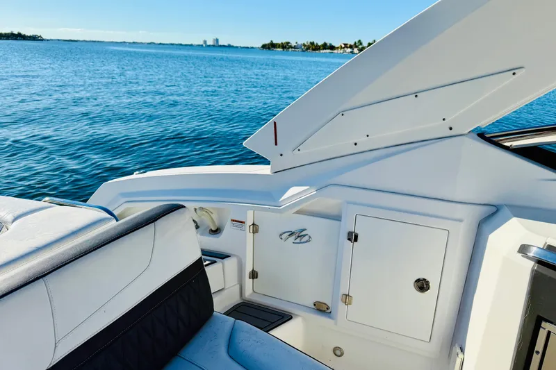 Slide: The Image of 2020 Monterey 328SS Super Sport boat interior with ocean view, featuring sleek design elements. - 20