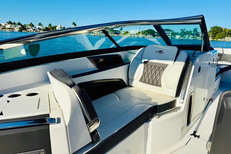 Slide: The Image of 2020 Monterey 328SS Super Sport boat interior with luxurious seating and scenic water view. - 21