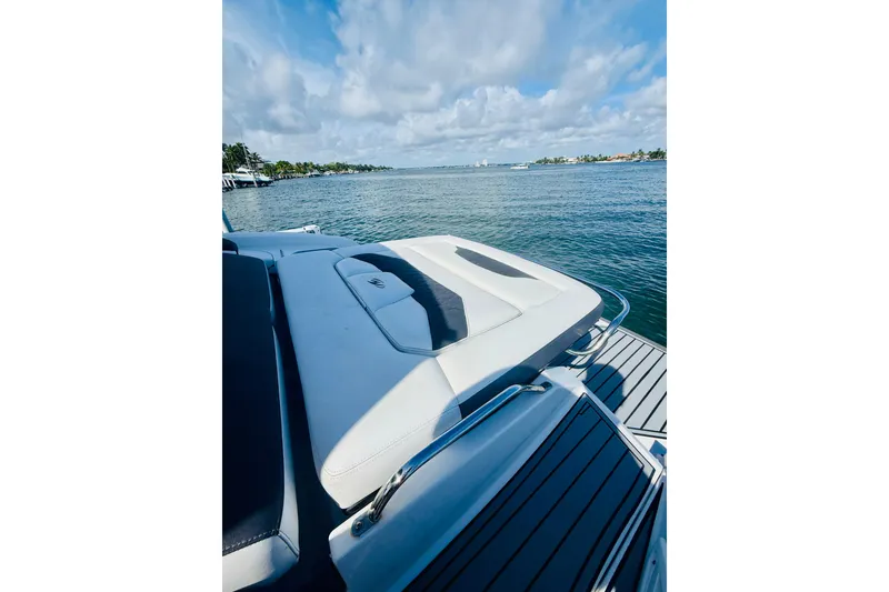 Slide: The Image of 2020 Monterey 328SS Super Sport boat on serene water with clear blue sky. - 30