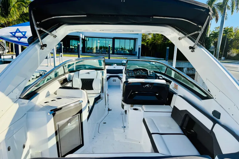 Slide: The Image of 2020 Monterey 328SS Super Sport boat interior with luxurious seating and modern dashboard. - 6