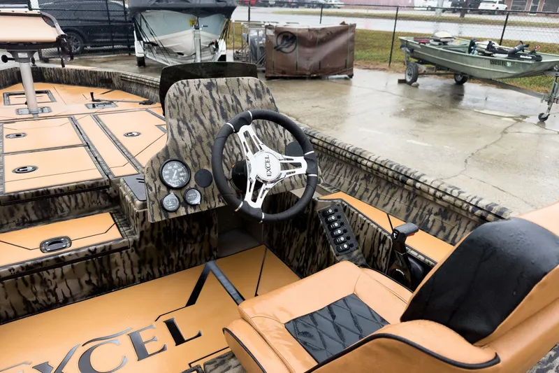Slide: The Image of 2026 Excel EX203C Crappie & Bass boat with tan and black seating, camo accents. - 13