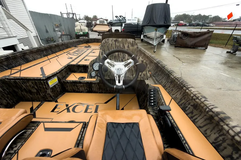 Slide: The Image of 2026 Excel EX203C Crappie & Bass boat with tan and black interior design. - 14
