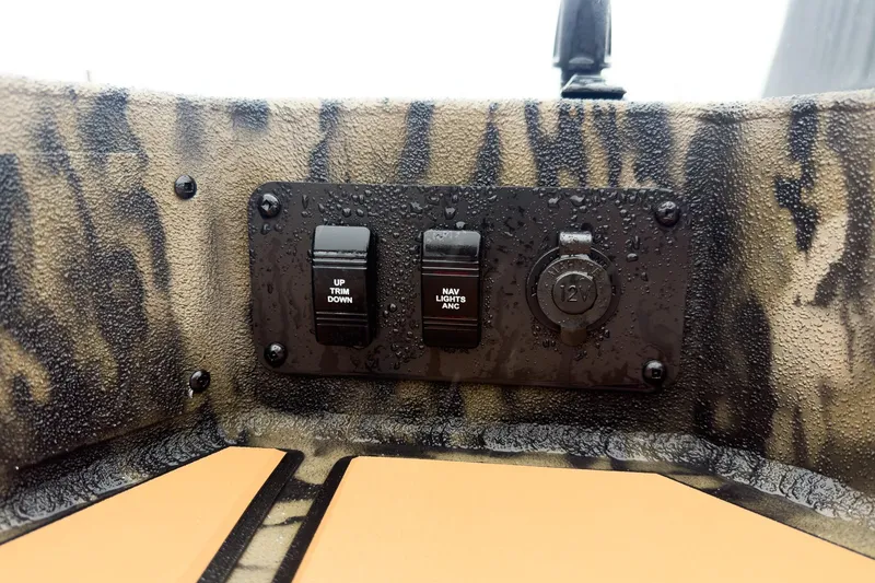 Slide: The Image of 2026 Excel EX203C Crappie & Bass boat interior with camo design and steering wheel. - 16