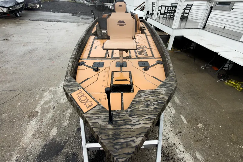 Slide: The Image of 2026 Excel EX203C Crappie & Bass boat interior with camo design and steering wheel. - 17