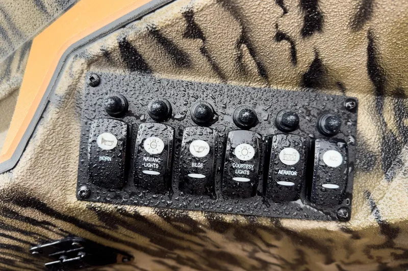 Slide: The Image of 2026 Excel EX203C Crappie & Bass boat deck with measurement ruler and camo design. - 23