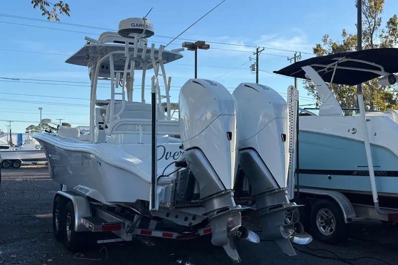 Slide: The Image of 2022 Yellowfin 26 Hybrid boat with dual outboard engines on a trailer. - 1