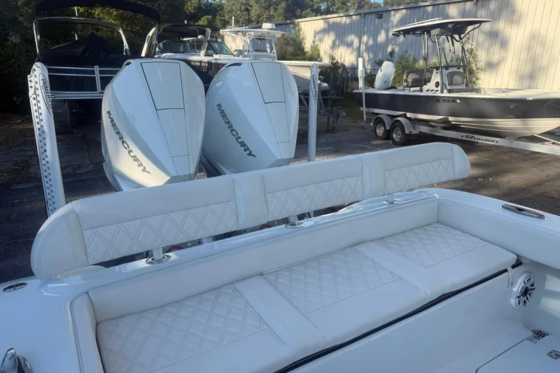 Slide: The Image of 2022 Yellowfin 26 Hybrid boat with dual Mercury engines and luxurious white seating. - 2