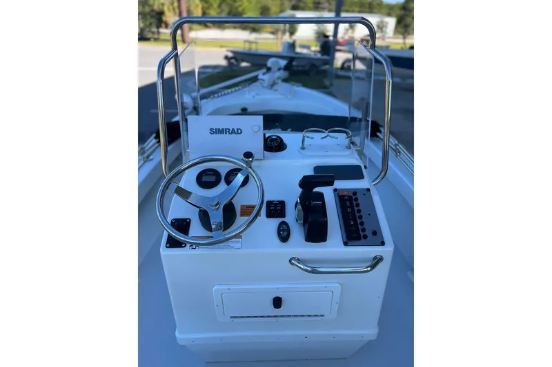 Slide: The Image of 2023 Parker 1801 Center Console boat dashboard with steering wheel and controls. - 11