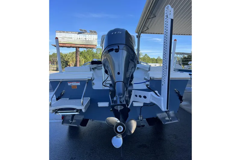Slide: The Image of 2023 Parker 1801 Center Console boat with outboard motor, displayed outdoors. - 17