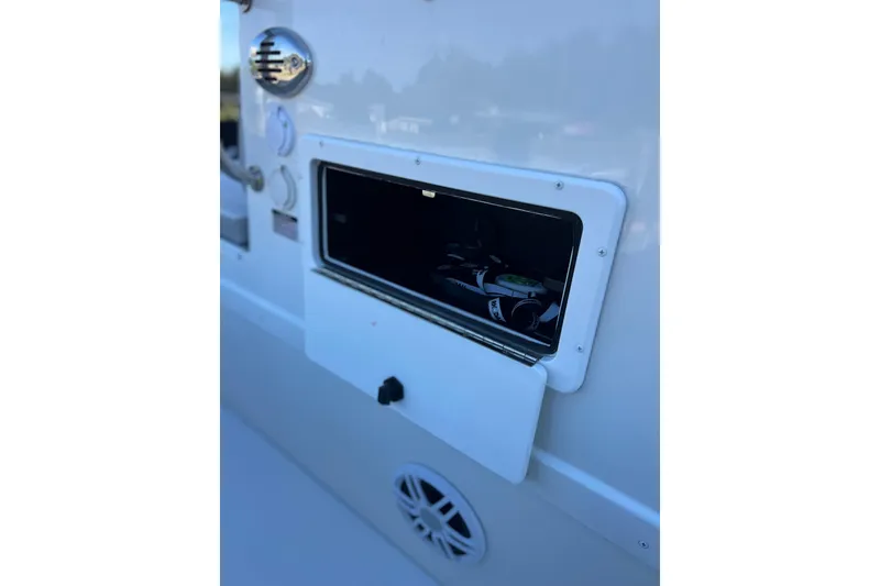 Slide: The Image of 2023 Parker 1801 Center Console boat storage compartment with open hatch and visible equipment. - 7