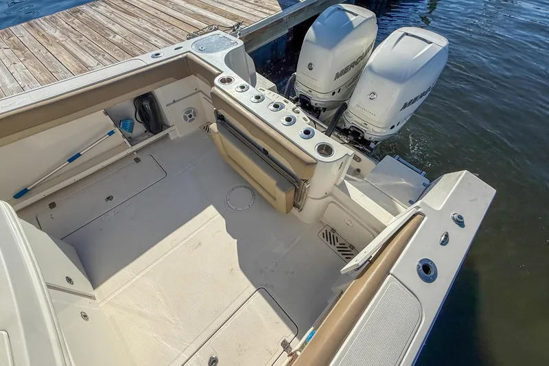 Slide: The Image of 2017 Sailfish 290 CC boat with dual Mercury engines at dock. - 17