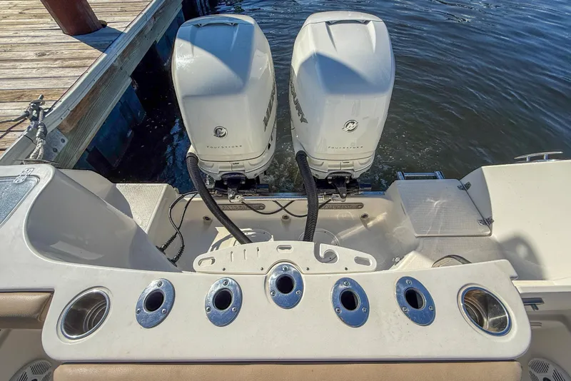 Slide: The Image of 2017 Sailfish 290 CC boat with twin Mercury outboard engines at dock. - 19