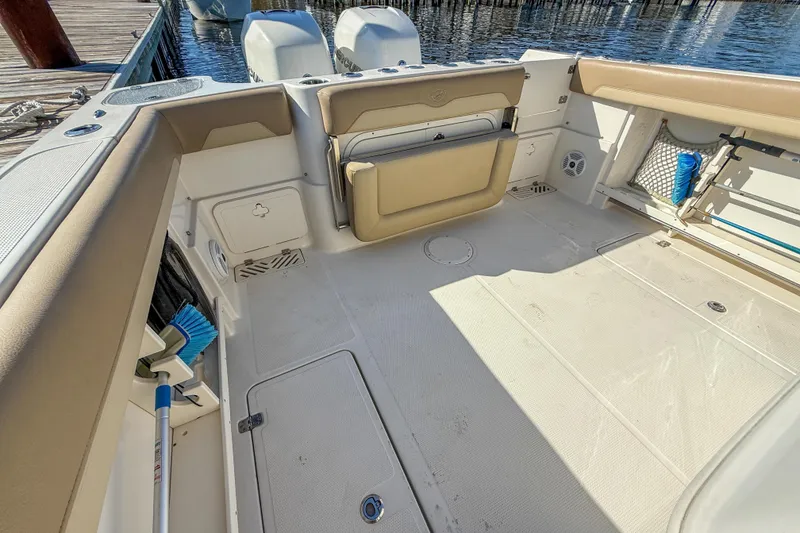 Slide: The Image of 2017 Sailfish 290 CC boat interior with clean deck and storage compartments. - 20