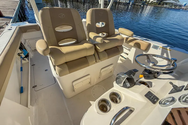 Slide: The Image of 2017 Sailfish 290 CC boat interior with dual captain's chairs and steering console. - 24