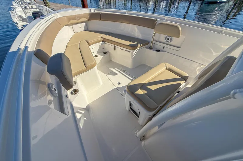 Slide: The Image of 2017 Sailfish 290 CC boat interior with beige seating and white deck. - 27