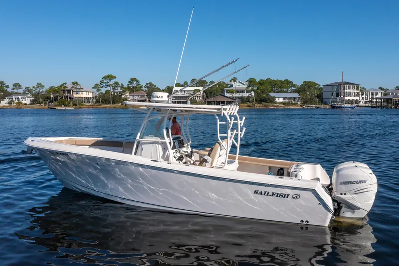 Slide: The Image of 2017 Sailfish 290 CC boat on calm water, featuring Mercury engines. - 3