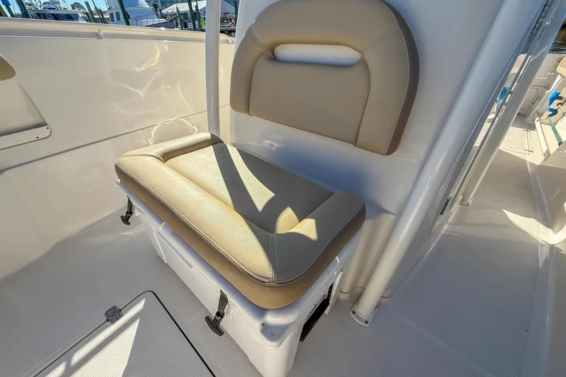 Slide: The Image of 2017 Sailfish 290 CC boat seat with beige cushion and integrated storage. - 31