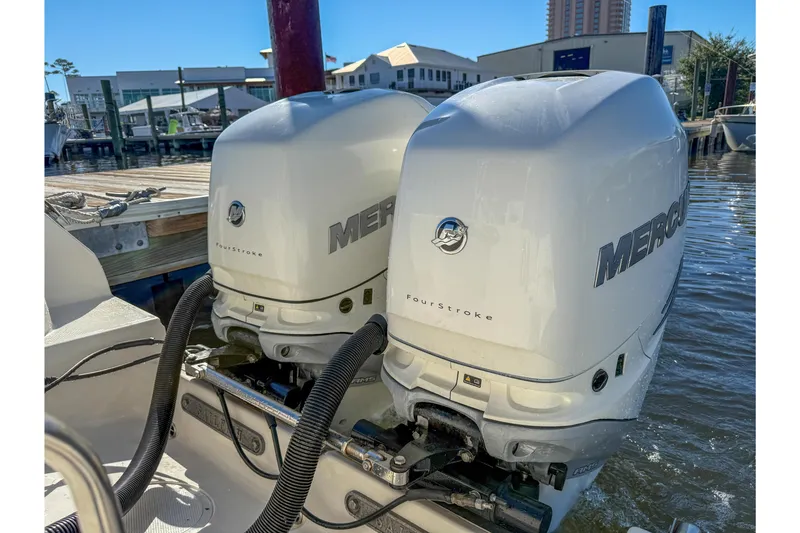 Slide: The Image of Twin Mercury FourStroke engines on a 2017 Sailfish 290 CC at a marina dock. - 33