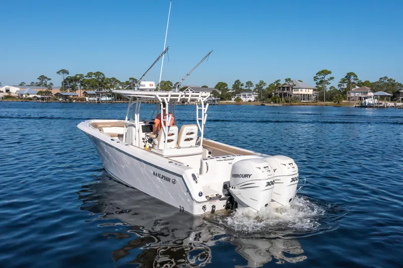 Slide: The Image of 2017 Sailfish 290 CC boat with twin Mercury engines on a calm lake. - 7