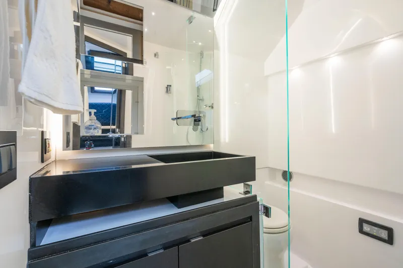 Slide: The Image of Manufacturer Provided Image: Modern bathroom in 2024 Cigarette 59 Tirranna boat with sleek black sink and glass shower. - 12