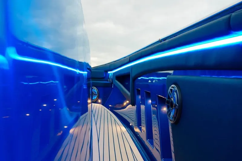Slide: The Image of 2024 Cigarette 59 Tirranna yacht with sleek blue design and ambient lighting. - 18